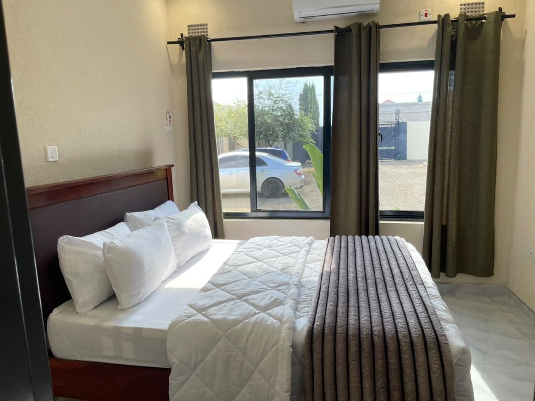 Parklands Apartments Livingstone — Main bedroom — air conditioning & garden outlook